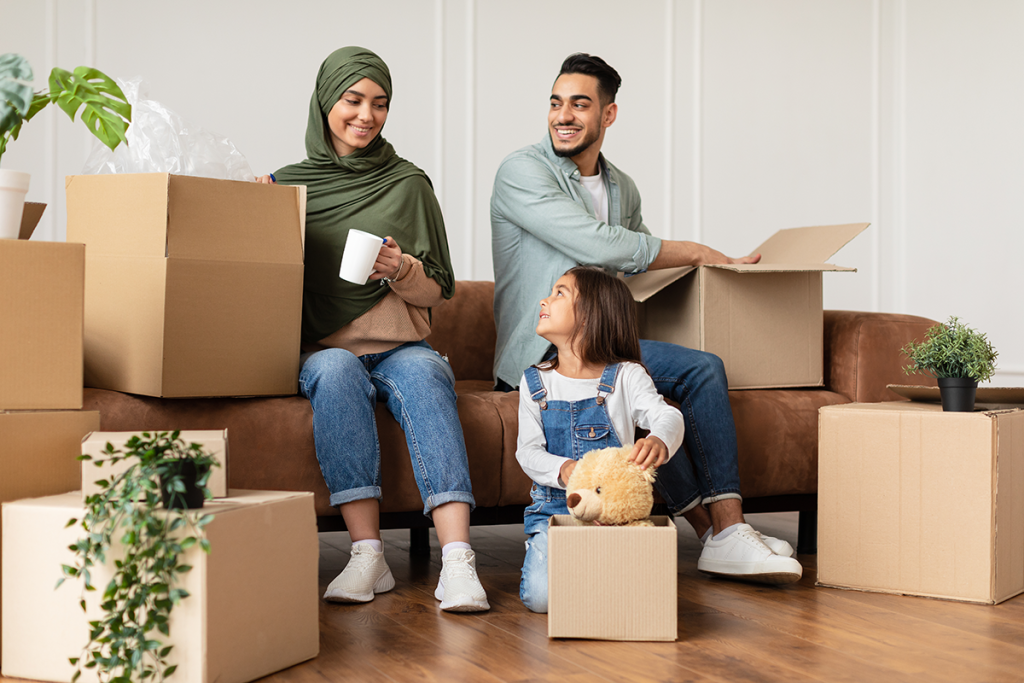 Asian family of mum, dad and daughter having moved into their perfect rental property in Leeds